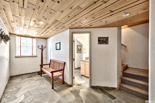 sitting room with wooden ceiling and light colored carpet