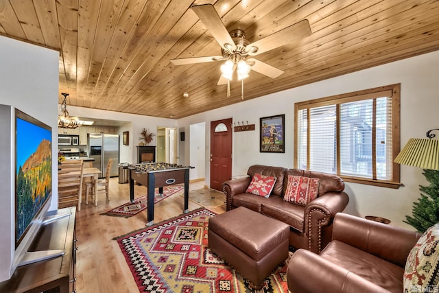 living room with ceiling fan with notable chandelier, wood ceiling, and light hardwood / wood-style floors