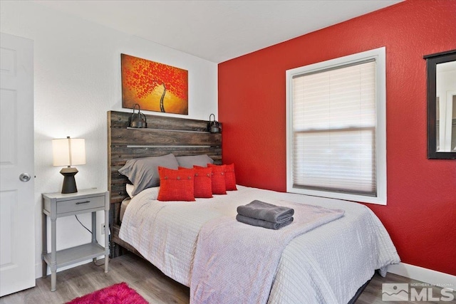 bedroom with hardwood / wood-style flooring