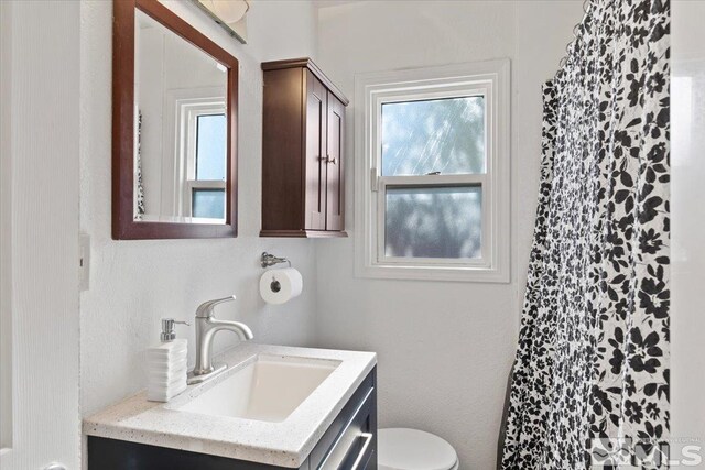 bathroom featuring vanity and toilet