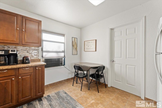 kitchen with white fridge, cooling unit, and backsplash