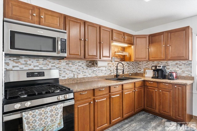 kitchen with sink, stainless steel appliances, and backsplash