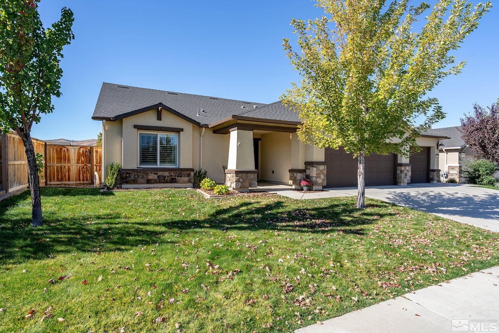 view of front of property featuring a front lawn and a garage