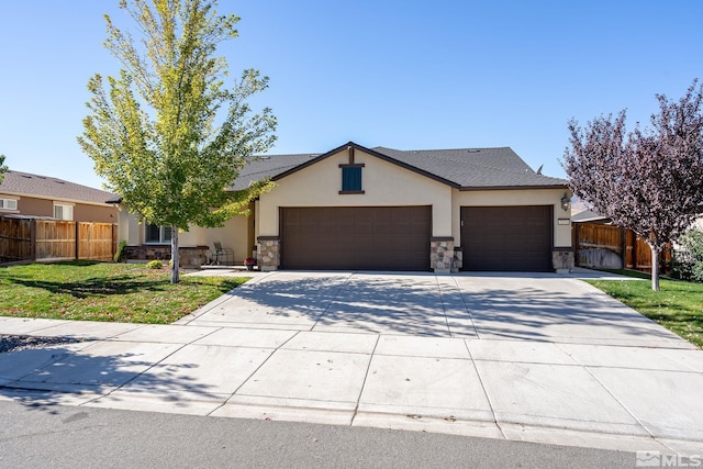 ranch-style house featuring a front yard and a garage