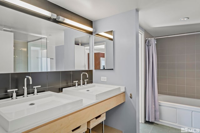 bathroom with shower / tub combo with curtain, sink, tile patterned floors, and tasteful backsplash