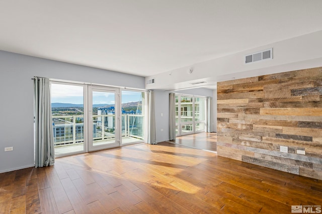 empty room with hardwood / wood-style floors