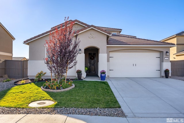 view of front of property featuring a garage and a front yard