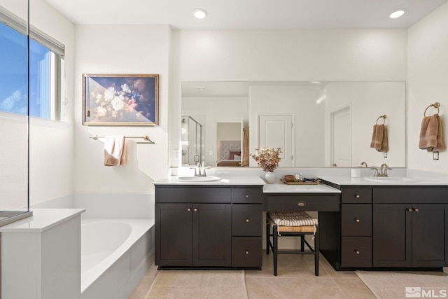 bathroom featuring tile patterned flooring, separate shower and tub, and vanity