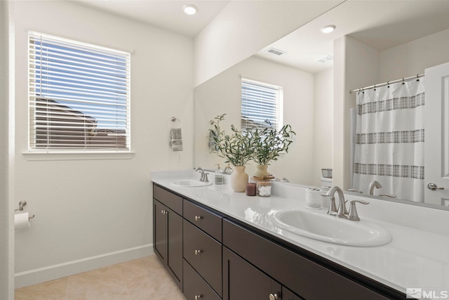 bathroom with tile patterned flooring and vanity