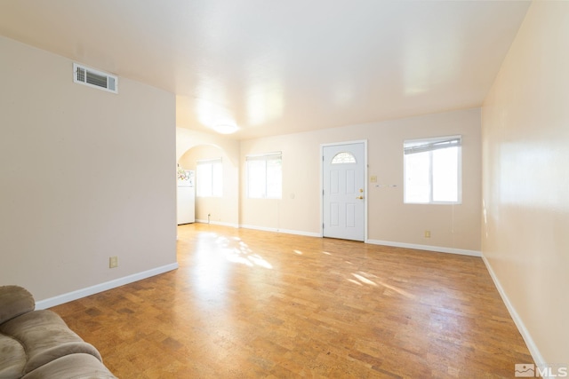 living room featuring light wood-type flooring and a wealth of natural light