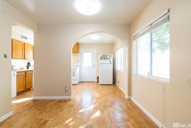 interior space featuring a healthy amount of sunlight and light hardwood / wood-style floors