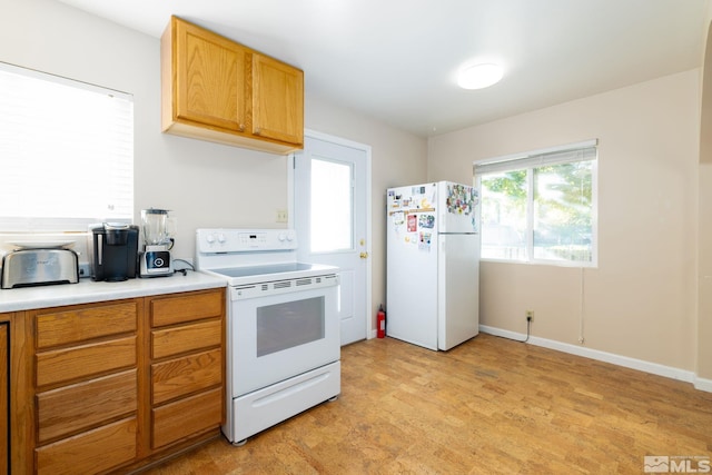 kitchen with light carpet and white appliances