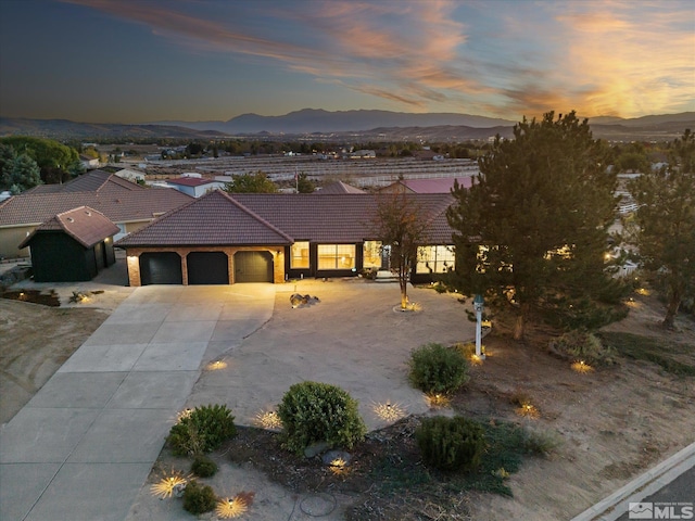 view of front of property featuring a mountain view and a garage