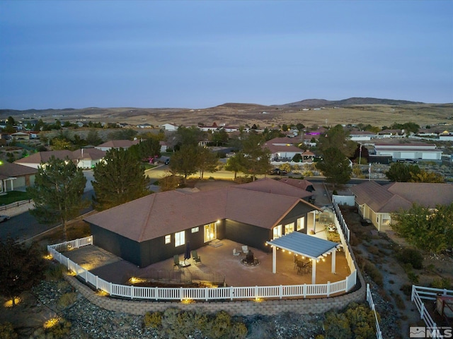 aerial view at dusk featuring a mountain view