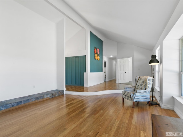 unfurnished room featuring hardwood / wood-style floors and high vaulted ceiling