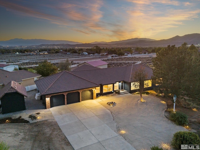 view of front of home featuring a mountain view and a garage