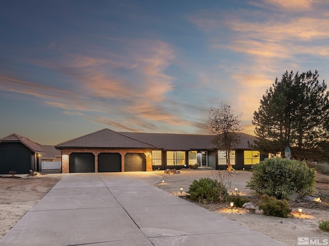 ranch-style home featuring a garage