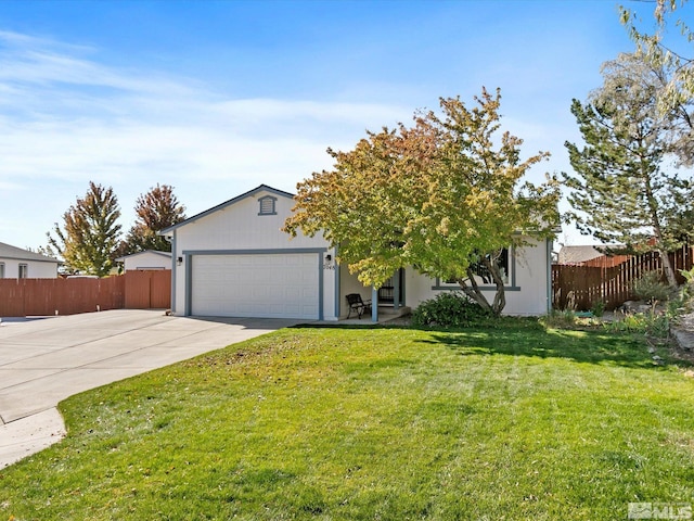 view of front of property featuring a front yard and a garage