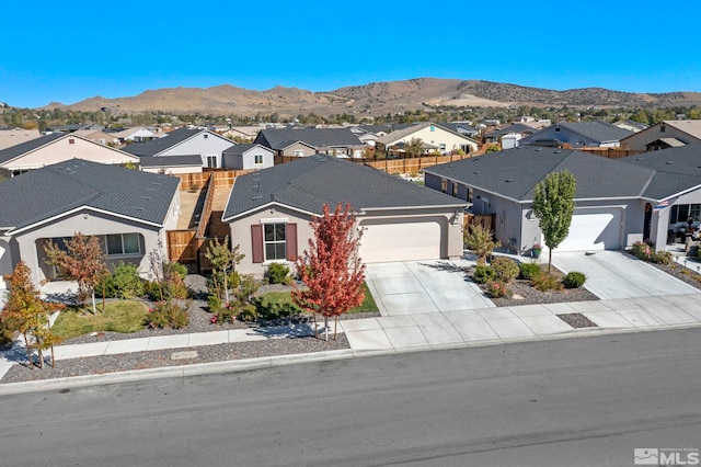 view of front of house with a garage and a mountain view