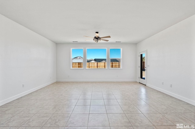 tiled empty room featuring ceiling fan