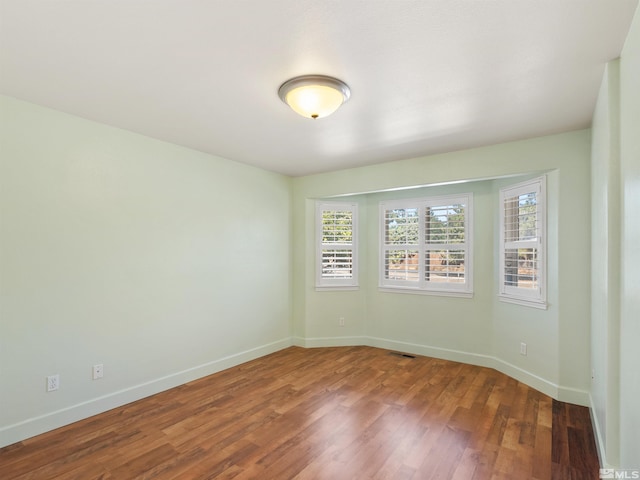 empty room with wood-type flooring