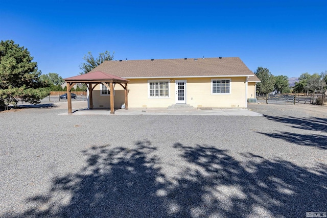 rear view of property with a gazebo and a patio area