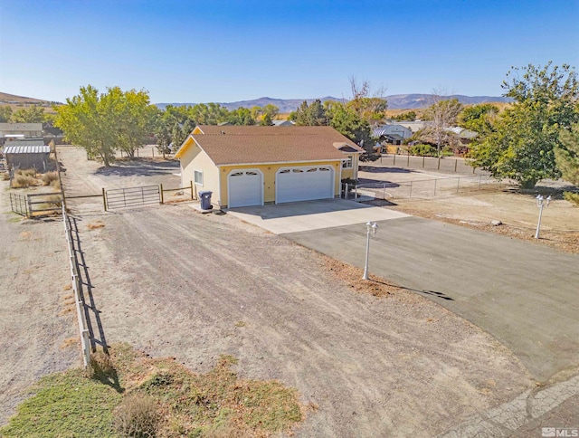 view of front of home with a mountain view and a garage