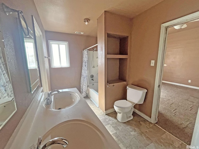 full bathroom featuring vanity, shower / tub combo, and toilet