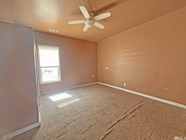 spare room featuring ceiling fan and carpet floors