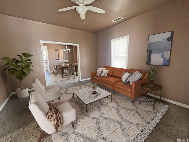 living room with carpet floors and ceiling fan with notable chandelier