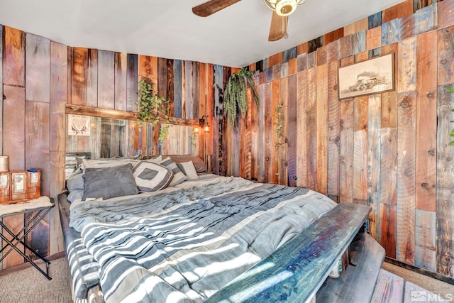 bedroom featuring wood walls, carpet floors, and ceiling fan