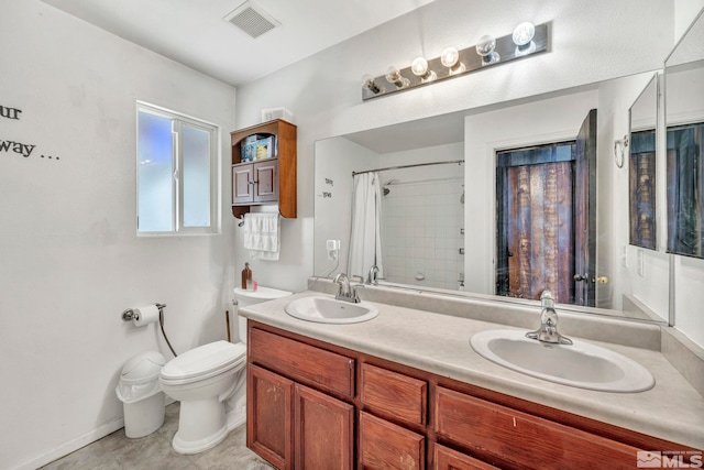 bathroom featuring vanity, toilet, and walk in shower