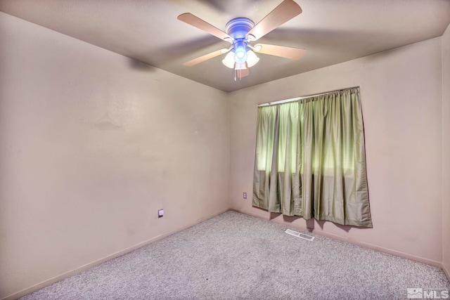 carpeted spare room featuring ceiling fan