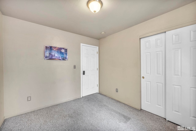 unfurnished bedroom with light carpet and a closet