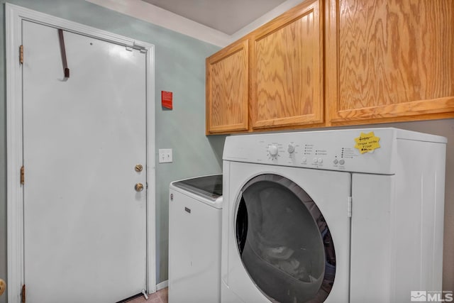 laundry area with cabinets and washer and clothes dryer