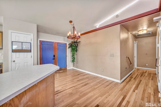 kitchen featuring light hardwood / wood-style flooring, decorative light fixtures, and a chandelier