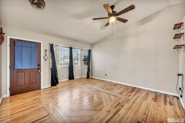 foyer with light hardwood / wood-style flooring, lofted ceiling, and ceiling fan