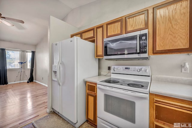 kitchen with white appliances, light hardwood / wood-style flooring, lofted ceiling, and ceiling fan