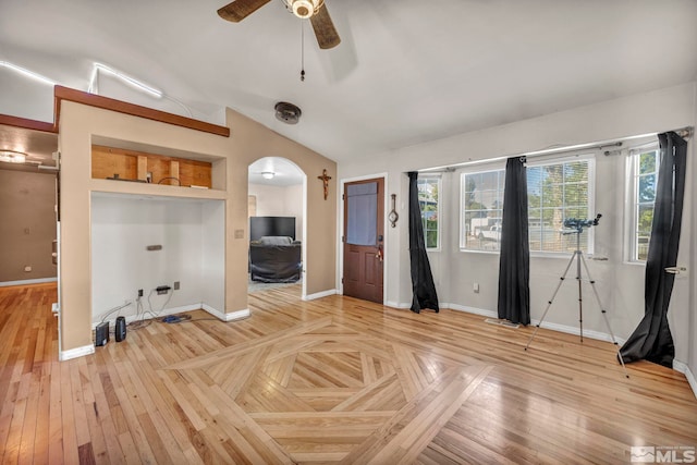 interior space with light hardwood / wood-style floors, vaulted ceiling, and ceiling fan