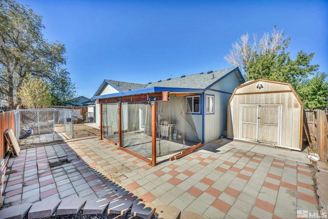 back of property featuring a shed and a patio area