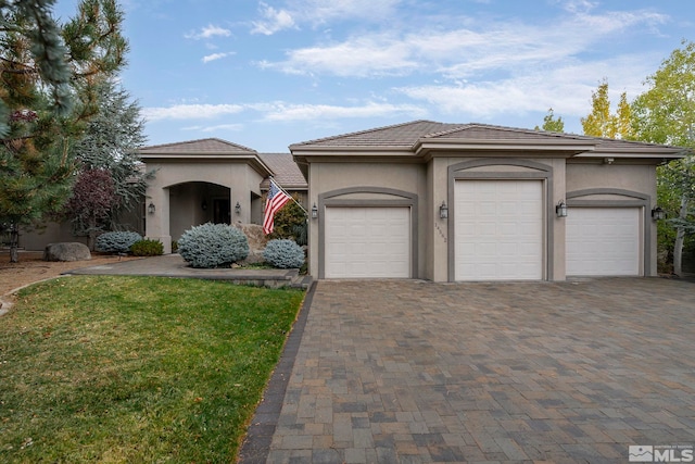 view of front of house with a front lawn and a garage