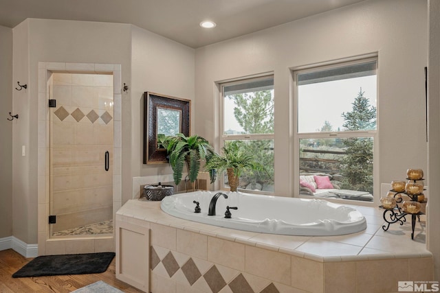 bathroom featuring separate shower and tub and hardwood / wood-style floors