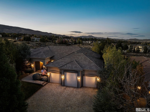 view of front of property with a mountain view and a garage