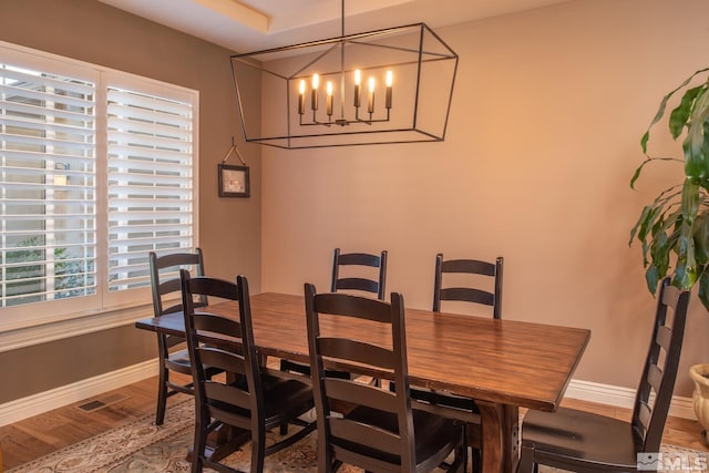 dining area featuring a chandelier and hardwood / wood-style flooring