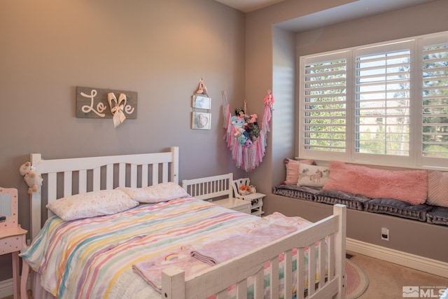 bedroom featuring multiple windows and carpet floors