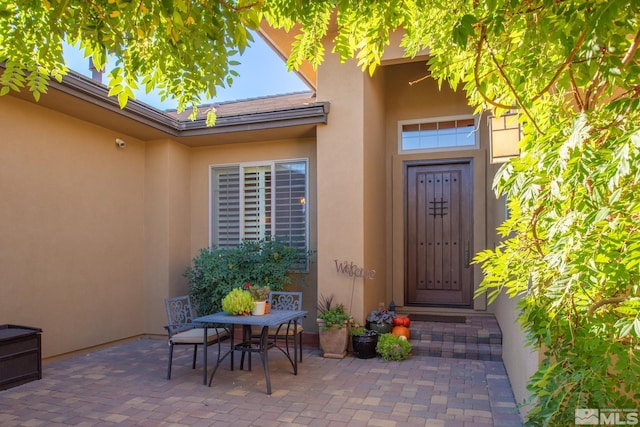 doorway to property with a patio area