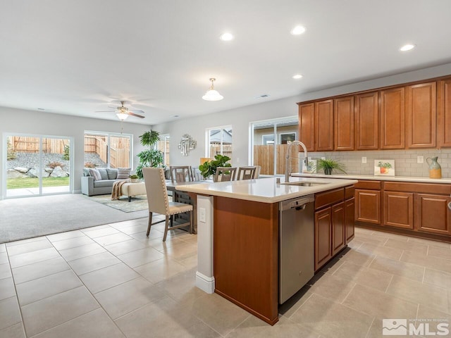 kitchen featuring dishwasher, a kitchen island with sink, sink, and plenty of natural light