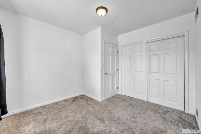 unfurnished bedroom with a closet and carpet