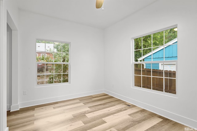 empty room with light wood-type flooring and ceiling fan