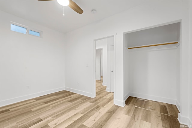 unfurnished bedroom featuring light hardwood / wood-style flooring, a closet, and ceiling fan